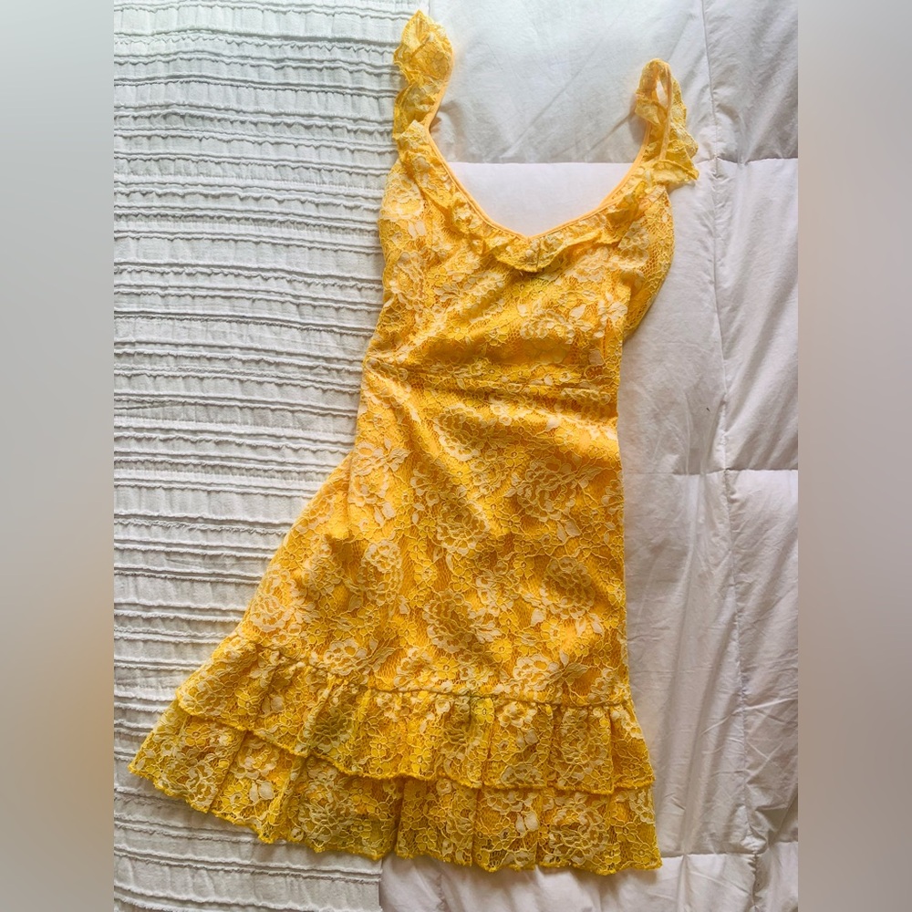 Flirty bright marigold cocktail dress with curly straps and flounce